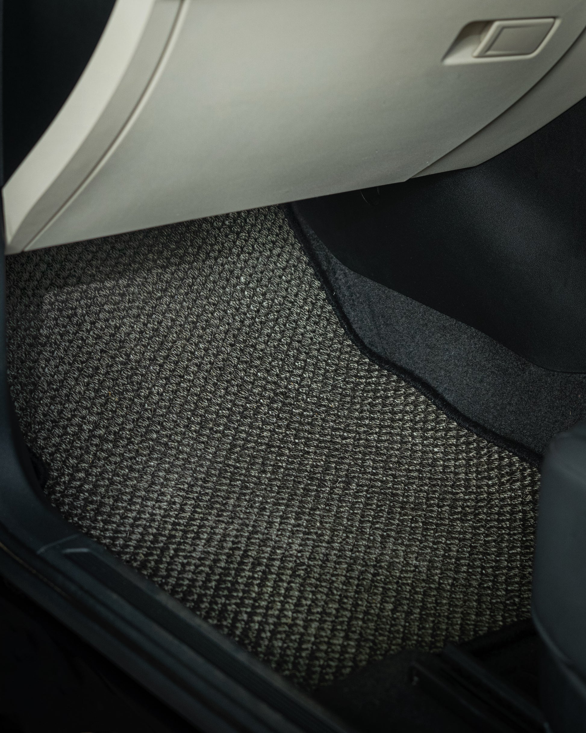 Nerova Kari Tiger Eye natural sisal car mats fully installed in BMW X3 — front and rear rows, charcoal sisal with cream leather interior