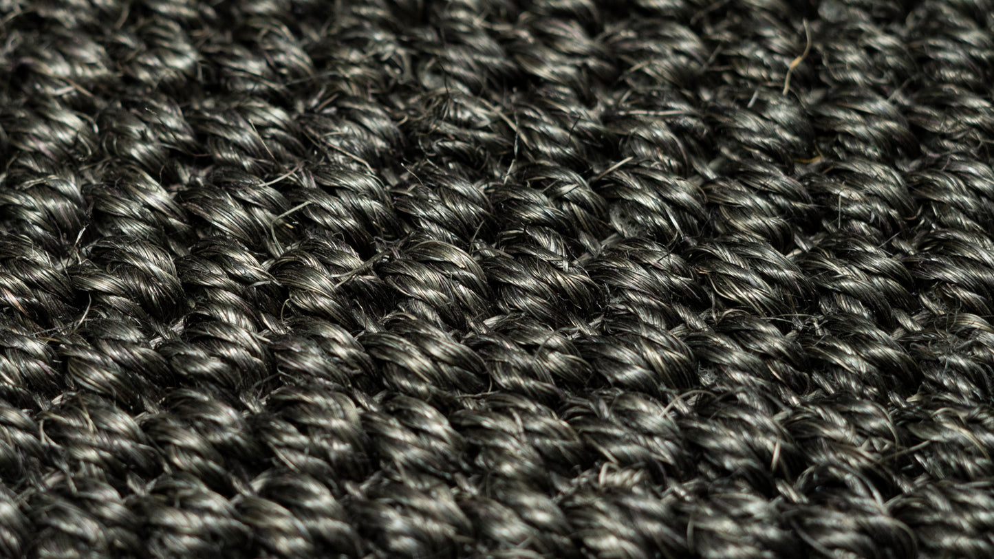 Nerova Kari Tiger Eye sisal texture closeup — deep charcoal natural sisal fibre, abrasion-resistant car mat material