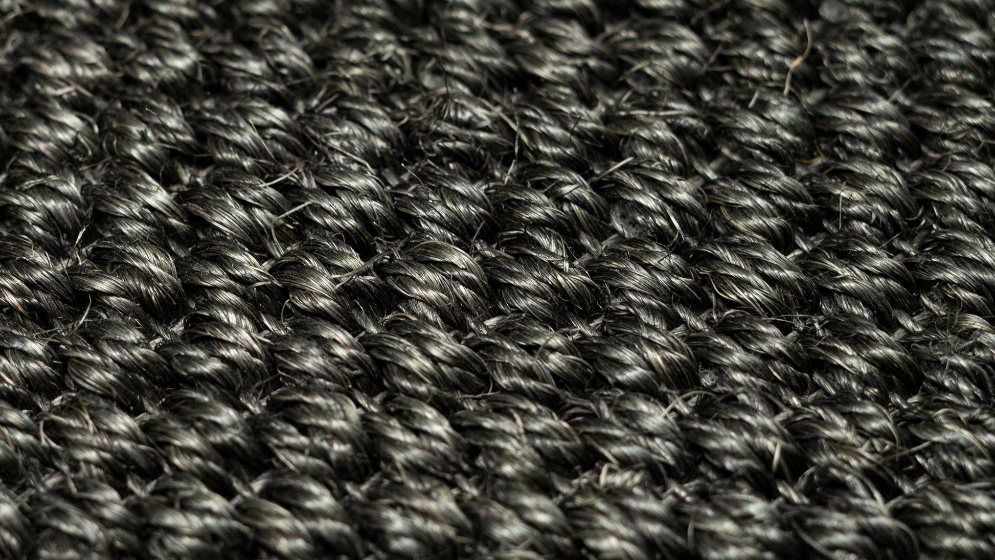 Nerova Kari Tiger Eye sisal texture closeup — deep charcoal natural sisal fibre, abrasion-resistant car mat material